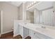 Bright bathroom featuring double sink vanity with large mirror, soaking tub, and walk-in shower at 5478 Somer Mill Rd, Douglasville, GA 30134