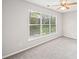 Bright bedroom with neutral carpet and paint, fan, and a large window overlooking the yard at 5478 Somer Mill Rd, Douglasville, GA 30134