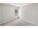 Bedroom features neutral paint and trim, large window and neutral carpet at 5478 Somer Mill Rd, Douglasville, GA 30134