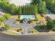 Aerial view of the community pool and playground, surrounded by trees, grass, parking and common areas at 5478 Somer Mill Rd, Douglasville, GA 30134