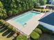 Community pool surrounded by a fence and lush shrubbery for privacy and a pleasant swimming experience at 5478 Somer Mill Rd, Douglasville, GA 30134