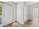 Bright entryway featuring wood floors, a white door with glass accents, and neutral wall paint at 5478 Somer Mill Rd, Douglasville, GA 30134