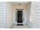 Close-up of a welcoming front entrance, including a sleek black front door, sidelights, and a transom window at 5478 Somer Mill Rd, Douglasville, GA 30134