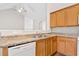 Open kitchen with a stainless steel sink, wooden cabinets, and granite countertops at 5478 Somer Mill Rd, Douglasville, GA 30134