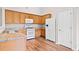 Bright kitchen featuring oak cabinets, white appliances, and granite countertops at 5478 Somer Mill Rd, Douglasville, GA 30134