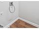 The unfinished utility room has wood-look floors, neutral walls and trim and an exposed electrical outlet at 5478 Somer Mill Rd, Douglasville, GA 30134