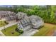 Aerial view of a gray house with a long driveway on a well manicured lawn at 6351 Granbury Nw Walk, Acworth, GA 30101