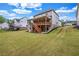 Expansive backyard with lush grass, a patio, and a multi-story house at 6351 Granbury Nw Walk, Acworth, GA 30101