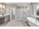 Beautiful bathroom featuring a soaking tub and tiled walk-in shower with glass enclosure at 6351 Granbury Nw Walk, Acworth, GA 30101