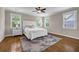 Bright bedroom with wood floors, ceiling fan, rug, and natural light from the windows at 6351 Granbury Nw Walk, Acworth, GA 30101