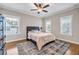 Charming bedroom with hardwood floors, a comfortable bed, and abundant natural light at 6351 Granbury Nw Walk, Acworth, GA 30101