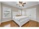 Cozy bedroom with hardwood floors, a large bed, and plenty of natural light at 6351 Granbury Nw Walk, Acworth, GA 30101