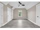 Neutral bedroom with gray plank flooring, a window, and white doors and trim at 6351 Granbury Nw Walk, Acworth, GA 30101