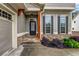 Inviting entryway featuring stone accents, a dark front door, and well-manicured landscaping at 6351 Granbury Nw Walk, Acworth, GA 30101