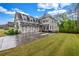 Beautiful two-story home with a three-car garage, lush lawn, and mature trees at 6351 Granbury Nw Walk, Acworth, GA 30101