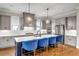Modern kitchen with stainless steel appliances, white countertops and blue bar stools at 6351 Granbury Nw Walk, Acworth, GA 30101