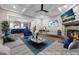 Virtually staged living room with stone fireplace, stylish furnishings, and open access to the kitchen for modern living at 6351 Granbury Nw Walk, Acworth, GA 30101