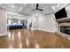 Open living room with coffered ceiling, stone fireplace, and hardwood floors next to the kitchen at 6351 Granbury Nw Walk, Acworth, GA 30101