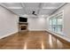 Bright, empty living room with stone fireplace, hardwood floors, and large windows at 6351 Granbury Nw Walk, Acworth, GA 30101
