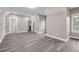 Spacious living room featuring gray plank flooring and a modern neutral paint color at 6351 Granbury Nw Walk, Acworth, GA 30101