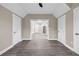 Open living room with gray plank flooring and modern neutral paint color at 6351 Granbury Nw Walk, Acworth, GA 30101