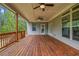 Relaxing covered patio with wood flooring, ceiling fans, and serene wooded views at 6351 Granbury Nw Walk, Acworth, GA 30101
