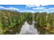 Picturesque view of the pond surrounded by trees and showing wooden docks in a quiet neighborhood at 6351 Granbury Nw Walk, Acworth, GA 30101