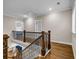 Upper landing with wood floors and iron railing detail at 6351 Granbury Nw Walk, Acworth, GA 30101