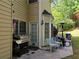 Back patio with grill, seating, and access to a green backyard at 2122 Riverbirch Ct, Lawrenceville, GA 30044