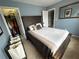 A blue bedroom features carpet, a bed, and a closet at 2122 Riverbirch Ct, Lawrenceville, GA 30044