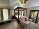 Primary bedroom with a four-poster bed, a chair, and large windows at 2122 Riverbirch Ct, Lawrenceville, GA 30044