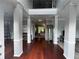 Grand foyer featuring soaring ceilings, hardwood floors, and decorative columns at 2122 Riverbirch Ct, Lawrenceville, GA 30044