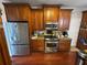An eat-in kitchen boasts stainless steel appliances, granite countertops, and beautiful wood cabinetry at 2122 Riverbirch Ct, Lawrenceville, GA 30044