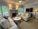 Inviting living room featuring a stone fireplace, cozy sofas, and a ceiling fan at 2122 Riverbirch Ct, Lawrenceville, GA 30044
