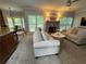 Comfortable living room featuring a stone fireplace, plush sofas, and abundant natural light at 2122 Riverbirch Ct, Lawrenceville, GA 30044