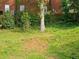 Spacious backyard with a gentle slope, showcasing a mix of grass and mature trees, ideal for outdoor activities at 2122 Riverbirch Ne Ct, Lawrenceville, GA 30044