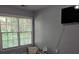 Bedroom with a large window for natural light and mounted TV at 2122 Riverbirch Ne Ct, Lawrenceville, GA 30044