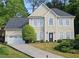 Charming two-story home featuring a gray roof, well-manicured lawn, and a convenient two-car garage at 2122 Riverbirch Ne Ct, Lawrenceville, GA 30044
