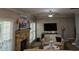 The inviting living room features a stone fireplace, ceiling fan, plush furniture, and ample natural light at 2122 Riverbirch Ne Ct, Lawrenceville, GA 30044