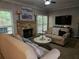 Comfortable living room with stone fireplace, neutral furniture, and natural lighting at 2122 Riverbirch Ne Ct, Lawrenceville, GA 30044