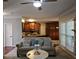 Cozy living room with natural light, hardwood floors, a fireplace, and a view into the kitchen at 2122 Riverbirch Ne Ct, Lawrenceville, GA 30044