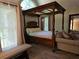 Luxurious main bedroom with a four poster bed, a couch, and lots of natural light at 2122 Riverbirch Ne Ct, Lawrenceville, GA 30044