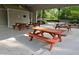 View of a community open-air pavilion with picnic tables on a concrete floor at 2122 Riverbirch Ne Ct, Lawrenceville, GA 30044