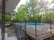 Backyard pool with a slide and bench that is partially surrounded by a tall iron fence at 2122 Riverbirch Ne Ct, Lawrenceville, GA 30044