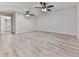 Bedroom with light wood floors and two ceiling fans, leading to an ensuite bathroom at 405 Sable Trace Cv, Acworth, GA 30102
