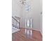 Elegant foyer boasting hardwood floors, a soaring ceiling with chandelier, and a grand entrance door at 405 Sable Trace Cv, Acworth, GA 30102