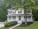 Charming two-story home featuring a welcoming front porch and a beautifully landscaped front yard at 405 Sable Trace Cv, Acworth, GA 30102