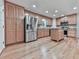 Well-lit kitchen featuring light wood cabinets, stainless steel appliances, and beautiful granite countertops at 405 Sable Trace Cv, Acworth, GA 30102