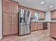 Close-up of kitchen area with stainless steel refrigerator and light wood cabinets at 405 Sable Trace Cv, Acworth, GA 30102