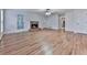Spacious living room featuring hardwood floors, a stone fireplace, and ample natural light at 405 Sable Trace Cv, Acworth, GA 30102